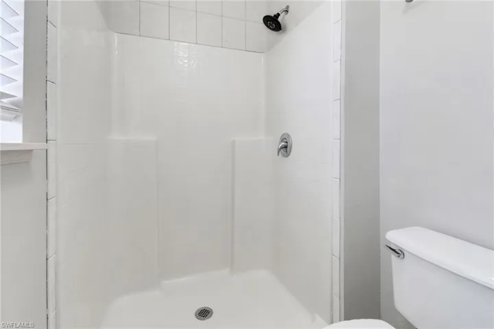 Bathroom with tiled shower and toilet