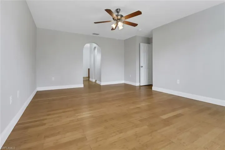 Empty room with light wood-type flooring and ceiling fan