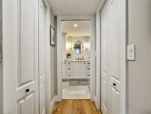 Bathroom with vanity, light wood-type flooring, a closet, and recessed lighting