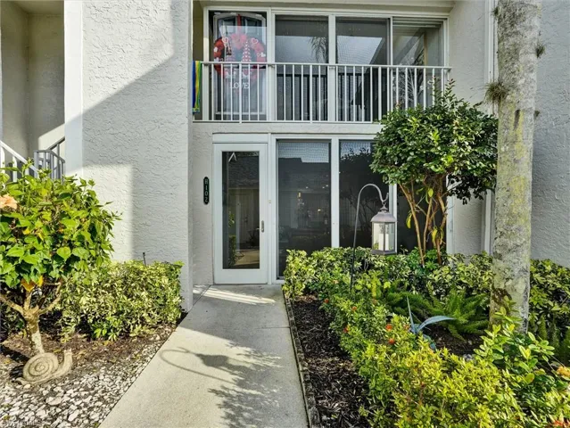 Entrance to property with stucco siding