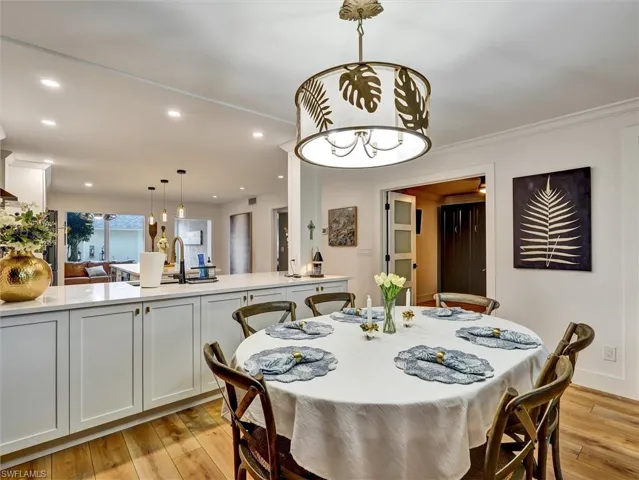 Dining area with recessed lighting and light wood-style flooring
