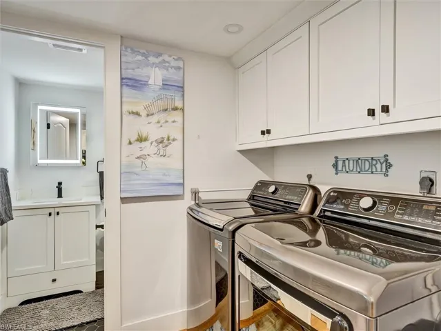 Laundry room featuring washing machine and dryer and cabinet space