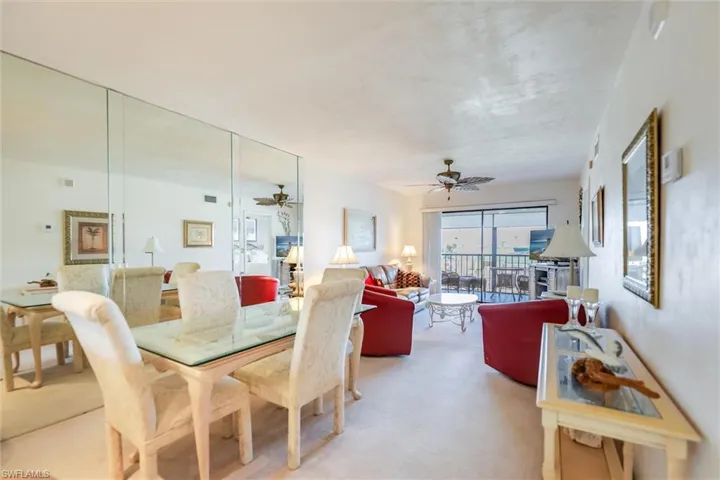 Carpeted dining area with ceiling fan