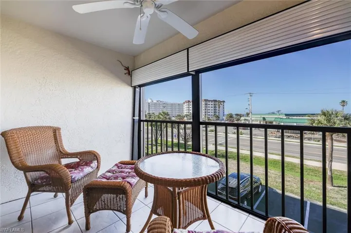 Balcony featuring a water view and ceiling fan