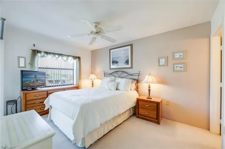 Bedroom featuring light colored carpet and ceiling fan
