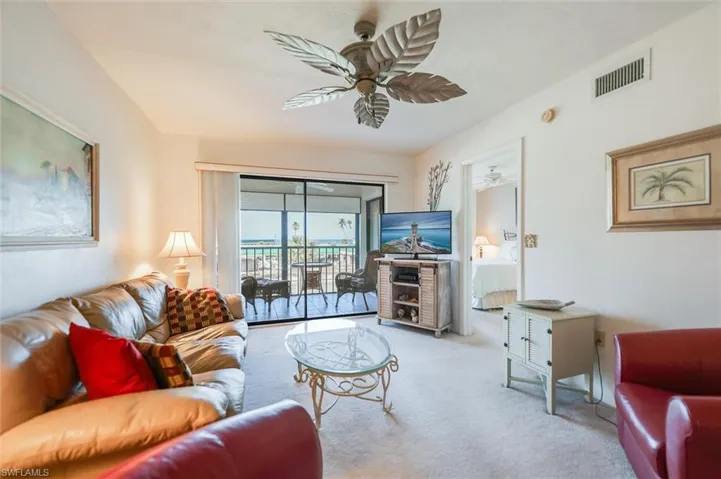 Living room with light carpet and ceiling fan