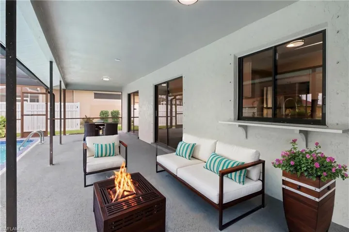 View of patio featuring an outdoor living space with a fire pit