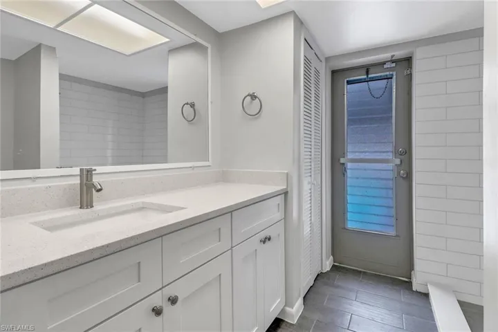 Bathroom with tile patterned floors and vanity