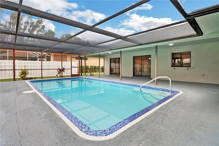 View of swimming pool with a patio area and a lanai