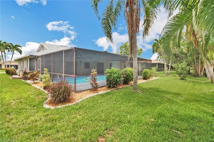View of yard with glass enclosure
