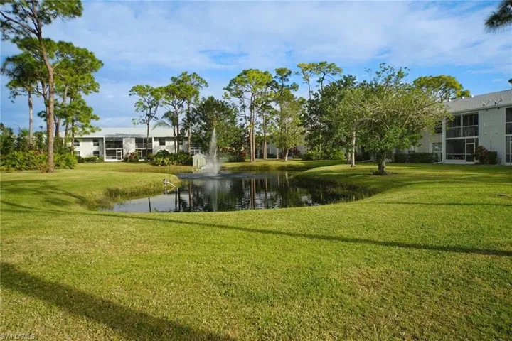 Surrounding community featuring a yard and a water view