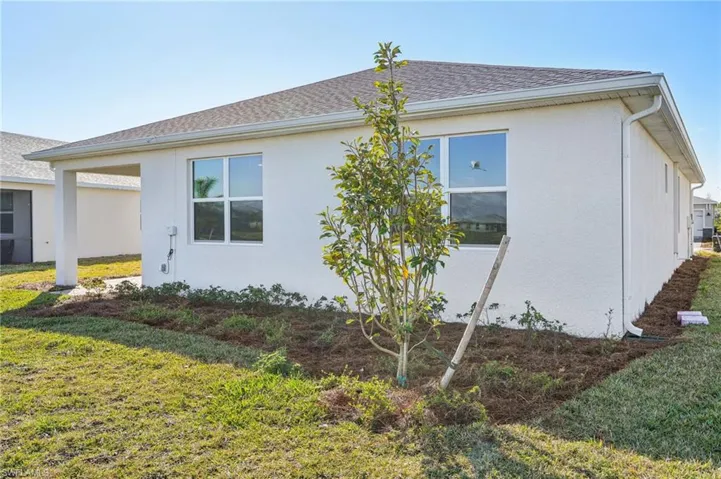View of side of home with a lawn