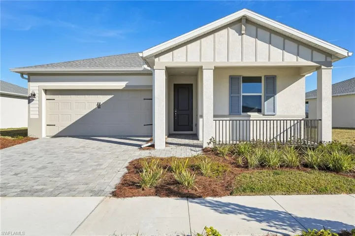 View of front of property with a garage and a porch