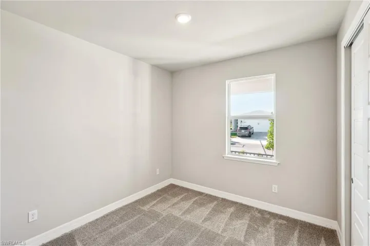 Spare room featuring carpet flooring