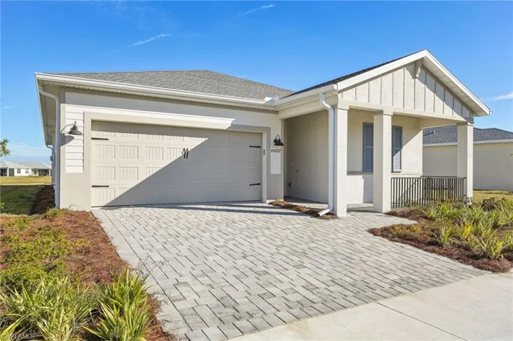 Single story home with a garage and covered porch