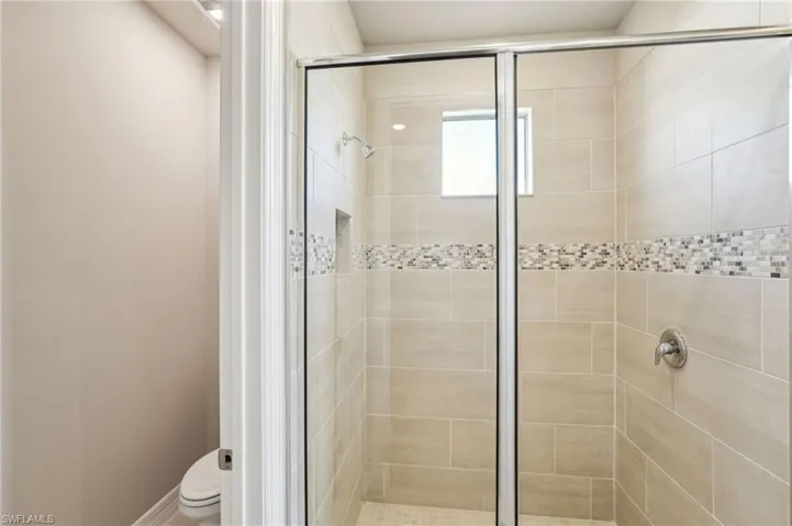 Bathroom featuring walk in shower and toilet