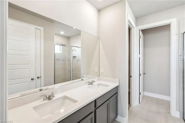 Bathroom featuring vanity and a shower with shower door