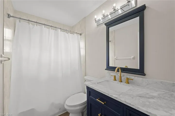 Full bath featuring vanity and shower / bath combo