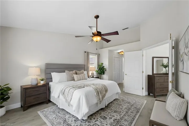 Bedroom with light wood finished floors, a ceiling fan, and a closet