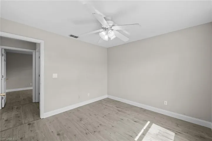 Empty room featuring ceiling fan and light wood-style flooring
