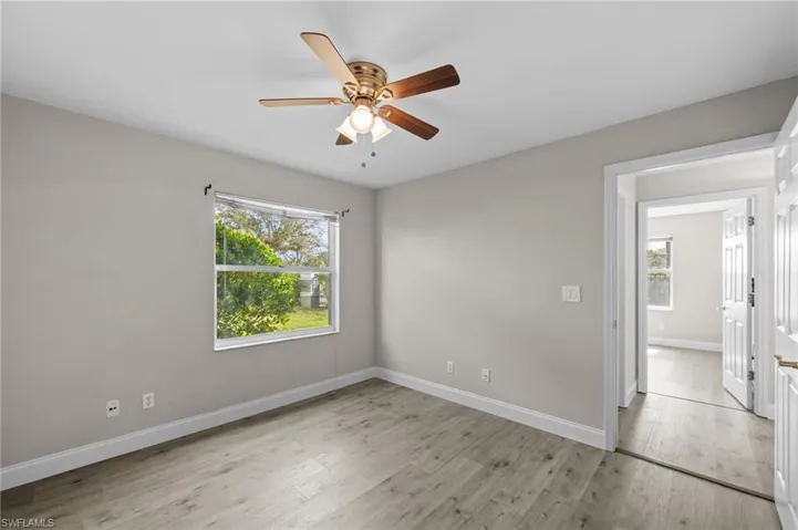 Unfurnished room featuring ceiling fan and light wood finished floors