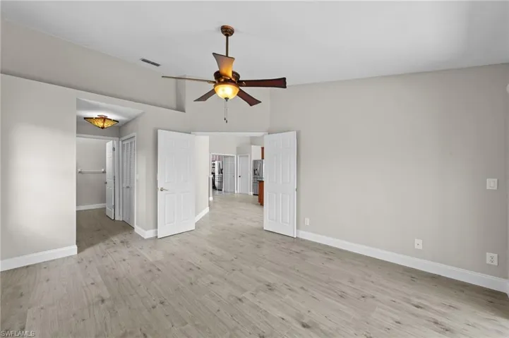 Unfurnished bedroom featuring light wood-type flooring and ceiling fan