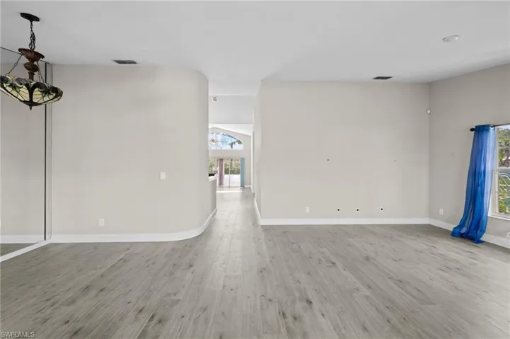 Spare room with light wood-type flooring and arched walkways