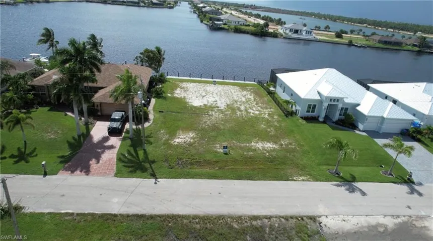 Birds eye view of property with a water view