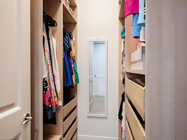 One side of custom primary closet