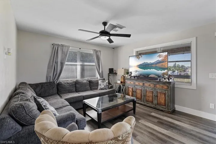 Living area featuring wood finished floors and ceiling fan