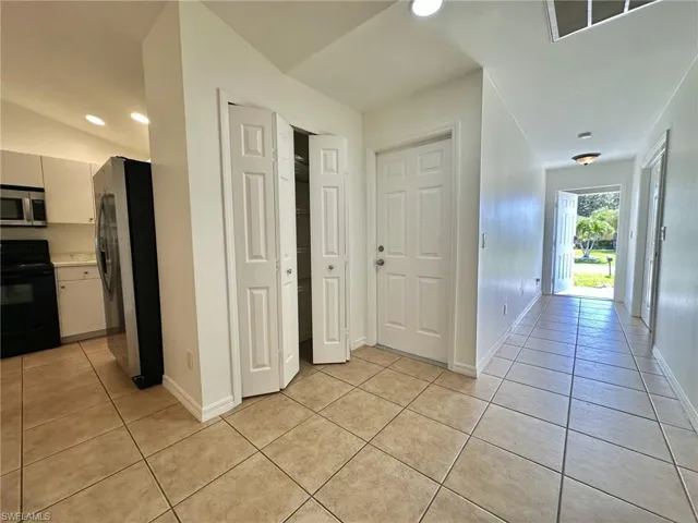 4317 View toward front entryway, double pantry and doorway to one car garage.