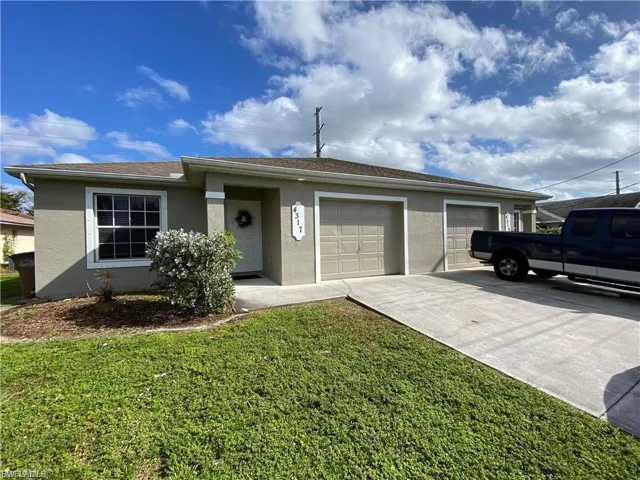 View of the 4317 Entry, the third bedroom/office/den window and driveway.