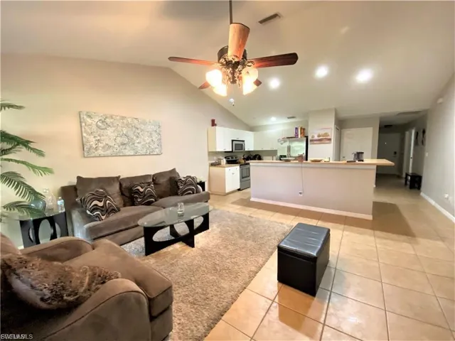 View of the ceiling fan  in the great room with ceiling fan and breakfast bar/entertainment bar and kitchen in the background