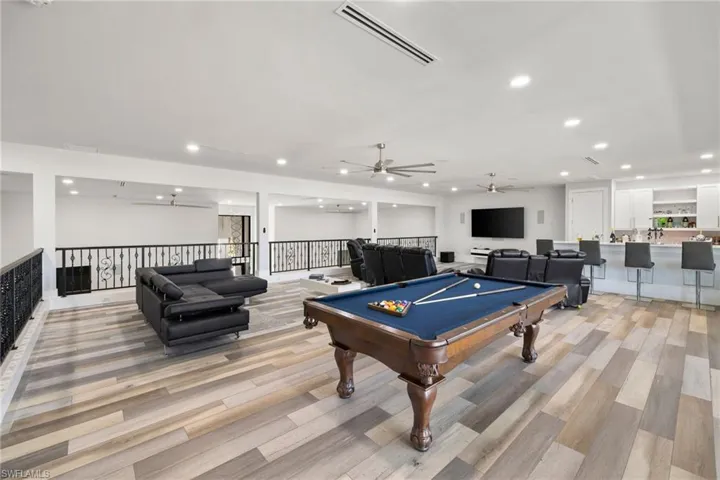 Playroom with a ceiling fan, billiards, recessed lighting, and light wood-type flooring