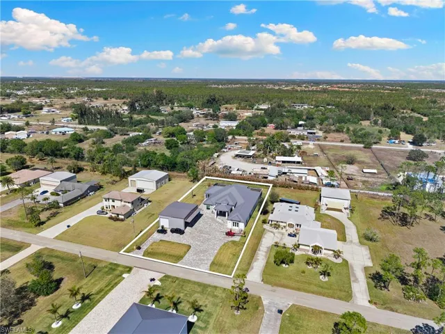 Aerial perspective of suburban area featuring a forest