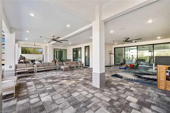 View of patio with ceiling fan and outdoor furniture