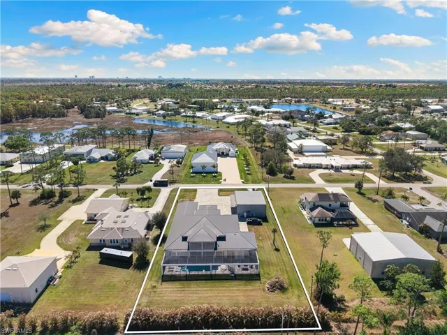 Aerial view of residential area featuring a nearby body of water