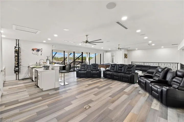 Living area featuring light wood-style flooring, recessed lighting, and a ceiling fan