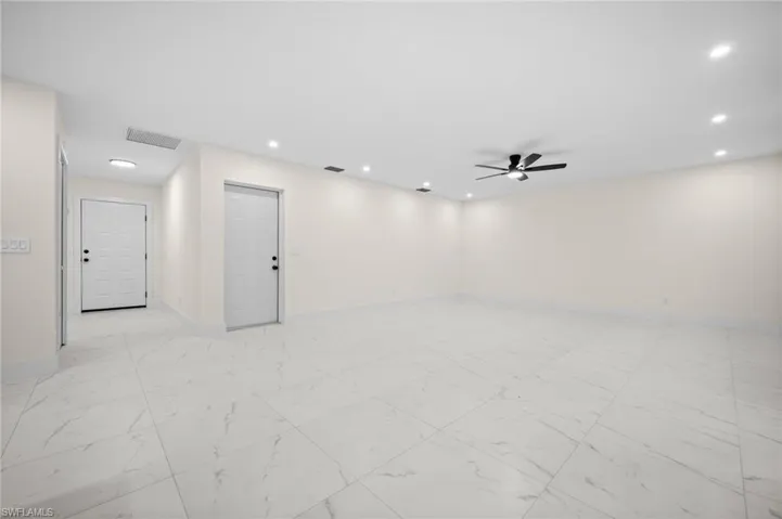 Unfurnished room with light marble finish flooring, ceiling fan, and recessed lighting