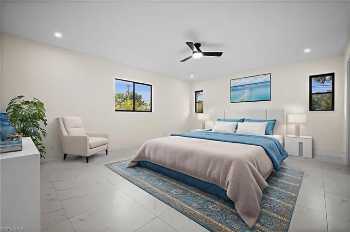 Bedroom featuring a ceiling fan, recessed lighting, and light marble finish floors
