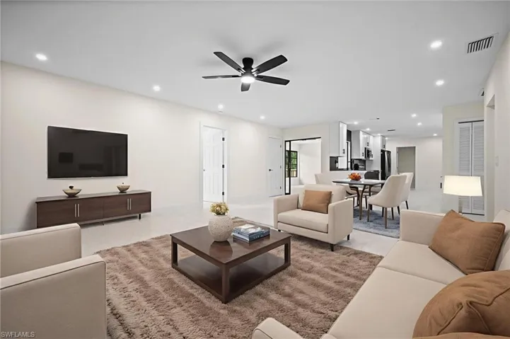 Living room with recessed lighting and a ceiling fan