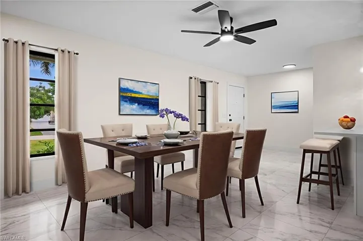 Dining room featuring light marble finish floors and ceiling fan