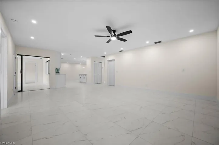 Spare room featuring light marble finish flooring, recessed lighting, and ceiling fan
