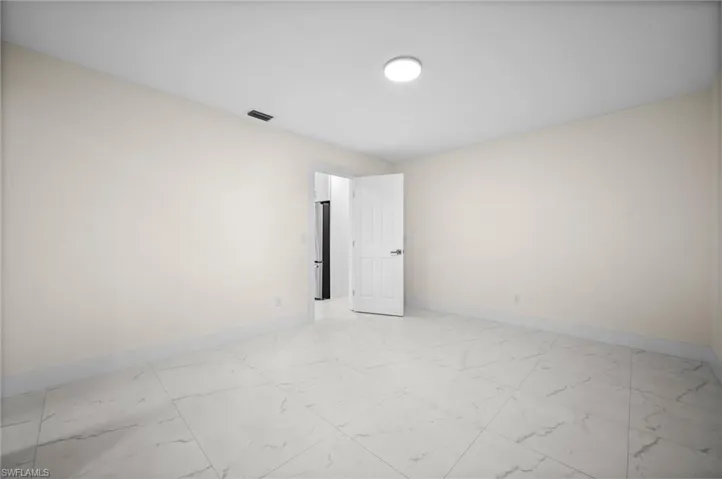Empty room with light marble finish floors and baseboards