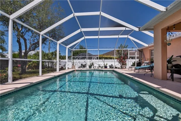 View of swimming pool with a patio area and a lanai