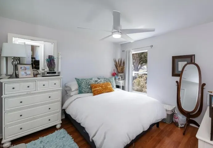 Bedroom featuring dark wood-style floors and a ceiling fan