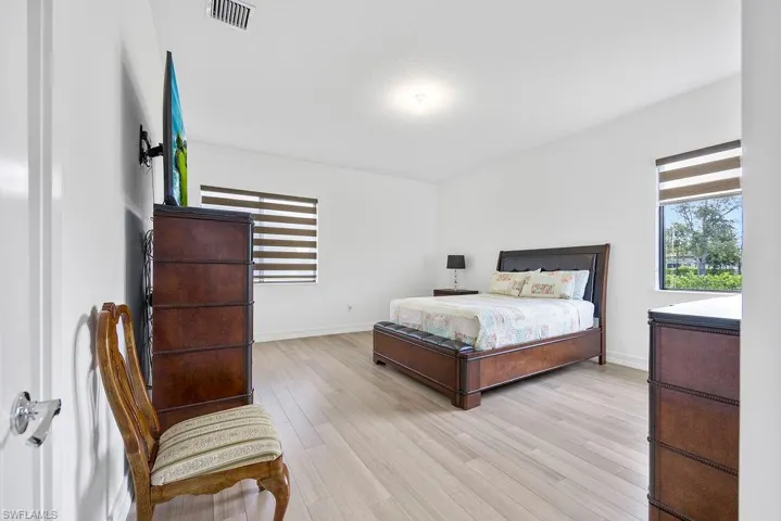 Bedroom with light hardwood / wood-style floors