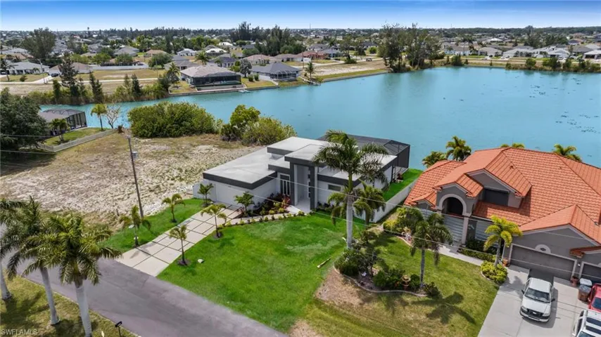 Birds eye view of property with a residential view and a water view