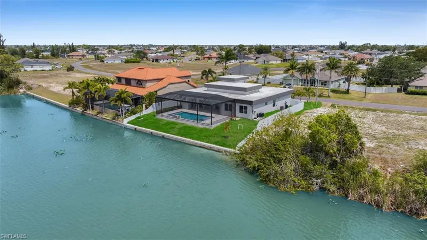 Birds eye view of property with a residential view and a water view
