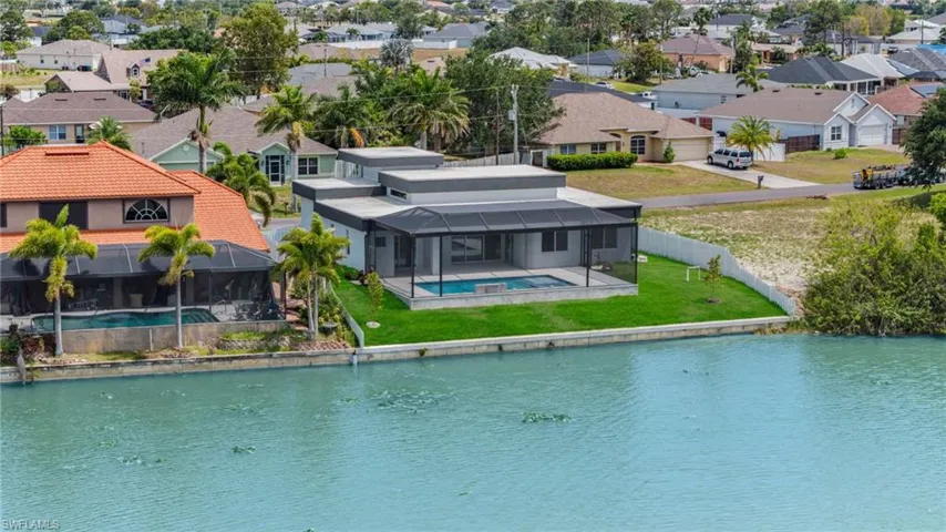 Birds eye view of property with a residential view and a water view